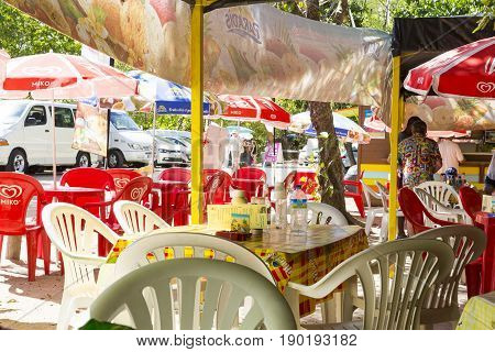 Les Saline Martinique - April 8 2017. Bar closed to the beach on the sand. Plastic chairs and table colored waiting for customers.