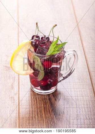 Ice cream and cherry juice on wooden background