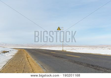 turning road on snow covered tibet plateau