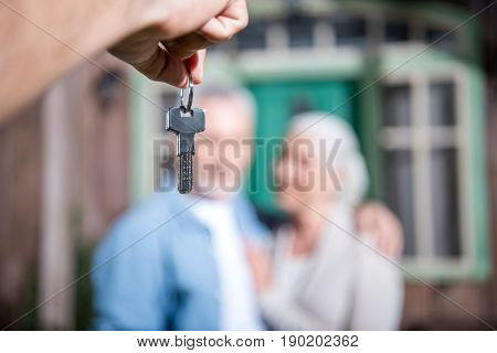 Saleman Giving Keys Of New House To New Owners, Selective Focus
