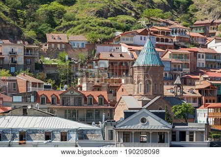 Tbilisi old part of town with cafe restaurants cobbled pavement and antique buildings. The Cathedral of Saint George (Surb Gevorg) 13th-century Armenian church in the historical quarter. Georgia.