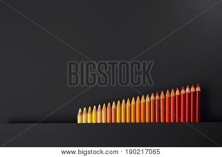 Colour pencils isolated on black background close up