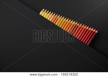Colour pencils isolated on black background close up