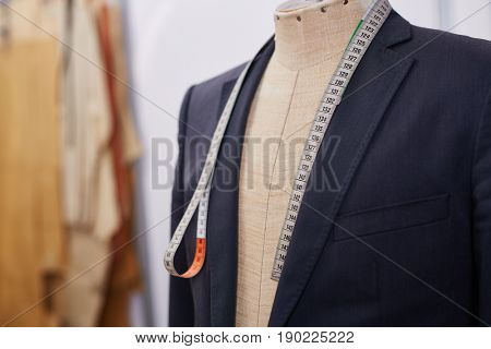 Custom made tailored suit on mannequin in atelier studio