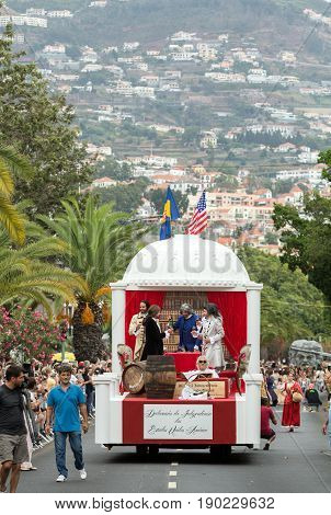 FUNCHAL MADEIRA PORTUGAL - SEPTEMBER 4 2016: Men in historical fashion dress raise toasts durnig historical and ethnographic parade of Madeira Wine Festival in Funchal. Madeira Portugal