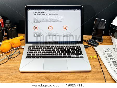 PARIS FRANCE - JUNE 6 2017: Apple Computers website on MacBook Retina in creative environment showcasing latest macOS High Sierra from Apple at WWDC 2017 - new Apple File system