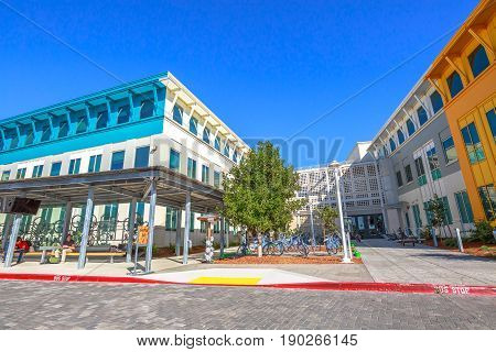 Mountain View, CA, United States - August 15, 2016: main entrance of Facebook headquarters building with parking and corporate branded blue bicycles. Facebook is located in Silicon Valley.