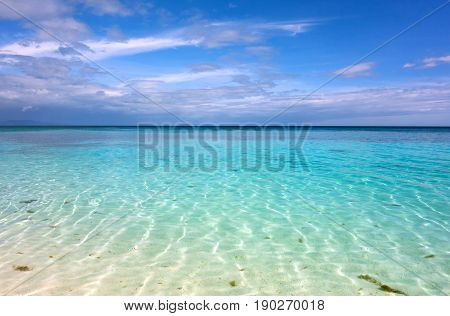 White clouds with blue sky over calm sea. Clear blue water with fantastic white sand beach. Summer outdoor nature holiday serenity. Kalanggaman Island Philippines. Background copy space.