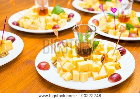 Cubes of yellow cheese on the plate