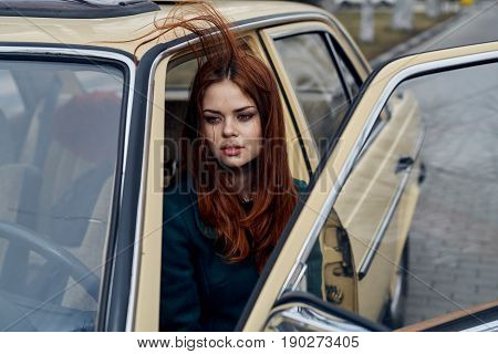 Woman driving a retro car, young woman driving a car.