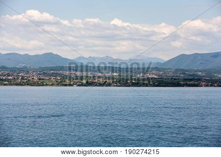 Landscape of the coast of Sirmione peninsula which divides the lower part of Lake Garda. It is a famous vacation place for a long time in northern Italy.