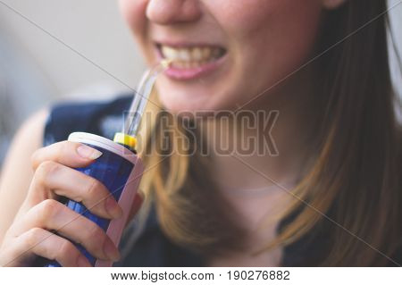 A Woman Using An Oral Irrigator In Bathroom. Selective Focus