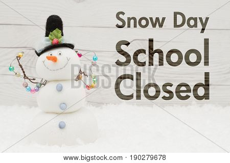 School canceled message A snowman with text Snow Day School Closed on weathered wood