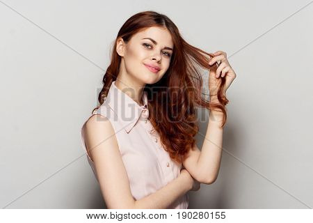 Young beautiful woman posing on light background.