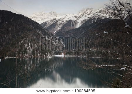Mountain lake against the backdrop of snow-capped mountains. Rizza Abkhazia