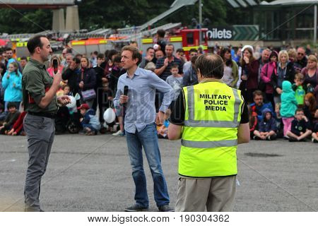 Beaulieu, Hampshire, Uk - May 29 2017: Compere Of The 2017 999 Show Interviewing A Participant, Watc