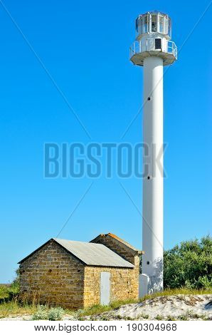 Old Lighthouse On The Beach Near The Sea. Lighthouse On The Coast Of The Island Dzharylgach.
