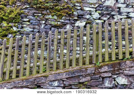 Wooden Fence At A Drystone Wall