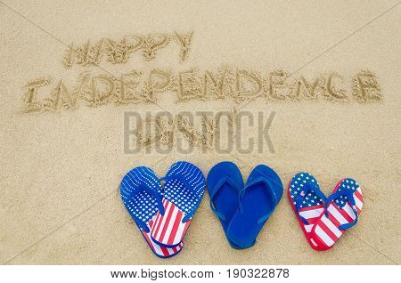 Independence USA background with flip flops on the sandy beach