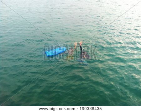Nueva Esparta, Venezuela September 3, 2016. People submerged in the sea, taking their hands and greeting the camera.