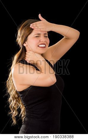Beautiful young lady Suffer crick after workout with a hand in her forehead, in a black background.