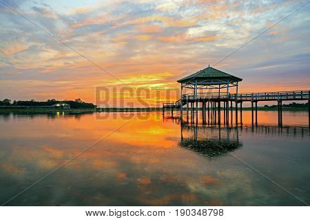 Sunset at the Pavilion on lake or pond or swamp of Bueng See Fai, Phichit, Thailand.