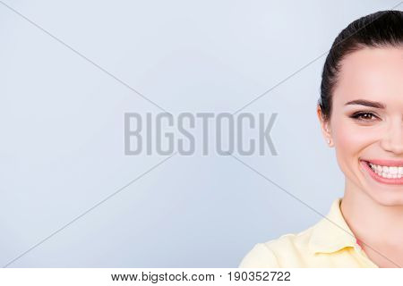 Half Face Cropped Portrait Of Cheerful Young Brunette With A Beaming Smile, Wearing Yellow Casual Ou