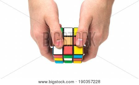 Estonia, Tallinn, May 30, 2017. Rubik's cube in hand on white background