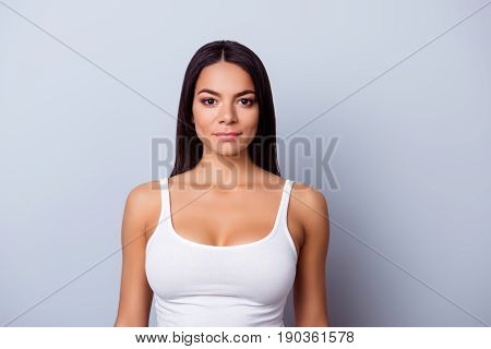 Portrait Of A Young Latino American Mulatto Girl. She Is In A Casual White Singlet Standing On The P
