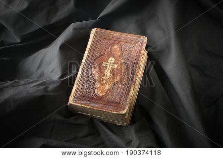 Bible On Dark Background. Old Fashioned Book. Religious Scriptures With Christian Symbolic. Ancient
