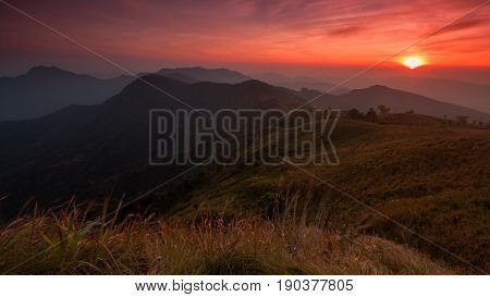 Sunset scene with the peak of mountain and cloudscape at Phu chi fa in Chiang raiThailand