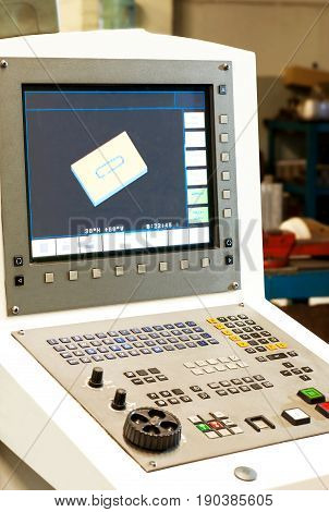 Computer numerical control machines bench-board and monitor with working program. Control panel of a programmable machine. Milling industry and lathe industry cnc technology and metal engineering.