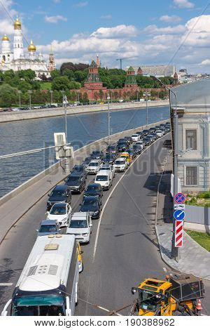 RUSSIA MOSCOW JUNE 8 2017: Road traffic on Sofiyskaya Embankment. View from Bolshoy Kamenny Bridge