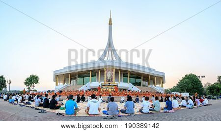 Bangkok, Thailand. - April 23, 2017 : Novice monk or priest and people sitting for meditation at Ratchamangkhala Pavillion of public park name Suan Luang Rama IX on evening time Bangkok, Thailand.