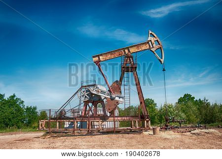 an oil pump is on a background mountains