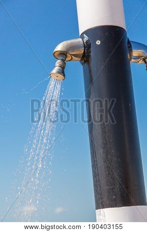 Water flowing from public shower on the beach