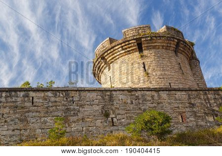 closeup on ancient tower with stone wall