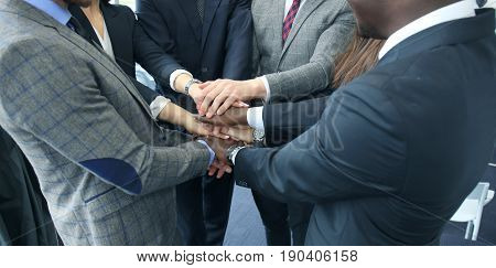 Businessman team in suit touching hands together. Selective focus