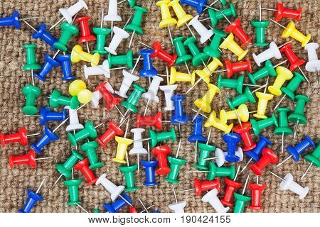 Push pins isolated on cloth sack background