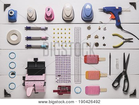 top view of the layout of tools for needlework and scrapbooking on wooden boards