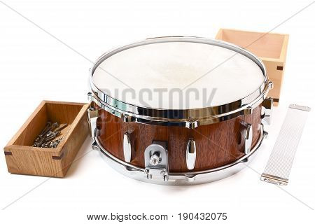 Brand new handmade wooden drum and spare parts in wooden box and snare wire isolated