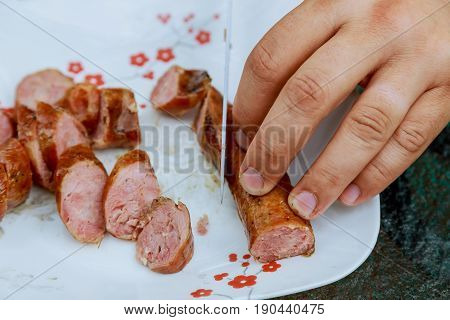 Cutting Sausage On The Plate Board Top View