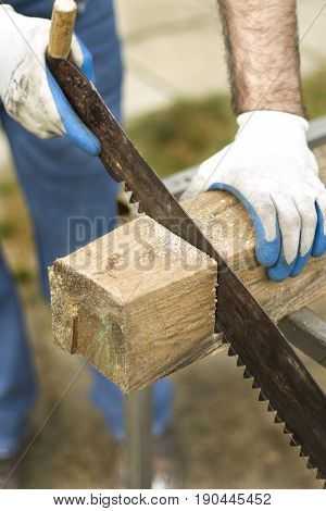 Carpenter's work on site. Trimming of a wooden scantlings.