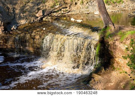 Small waterfall at sunny summer day Russia.