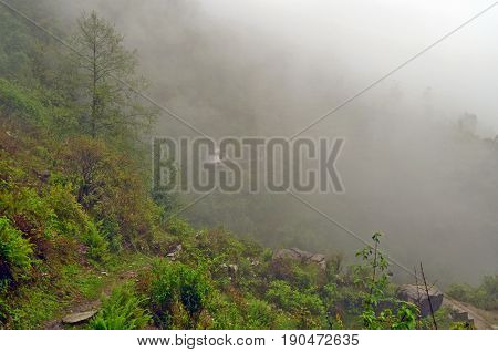Little temple on hill in fog near Landruk, Annapurna Conservation Area, Himalaya Mountains, Nepal