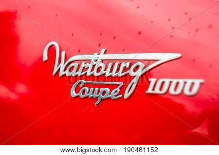 PAAREN IM GLIEN GERMANY - JUNE 03 2017: Emblem of the Wartburg 311 Coupe 1000 closeup. Focus on the center. Exhibition 