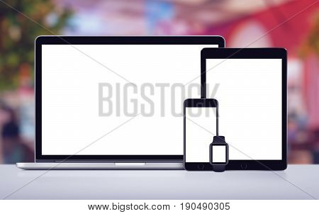 Mockup consisting of laptop, tablet pc smartwatch and mobile smartphone with blank white screens. For adaptive responsive design presentation. All gadgets in focus.
