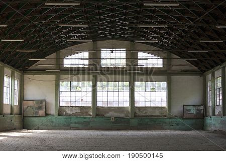 Old fashioned riding hall with sandy covering without people