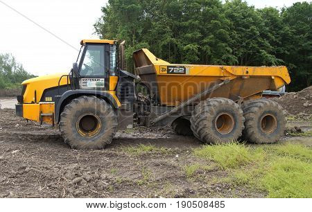 Almere Poort, Flevoland, The Netherlands - June 10, 2017: Yellow JCB 722 Articulated Dump Truck parked on a construction site in the city of Almere. Nobody in the dumper.