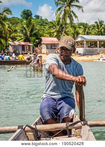 Ambatozavavy Nosy Be Madagascar - December 19 2015: Boatman on his traditional wood pirogue with outrigger in the fishing Ambatozavavy village on the Nosy Be island Madagascar.